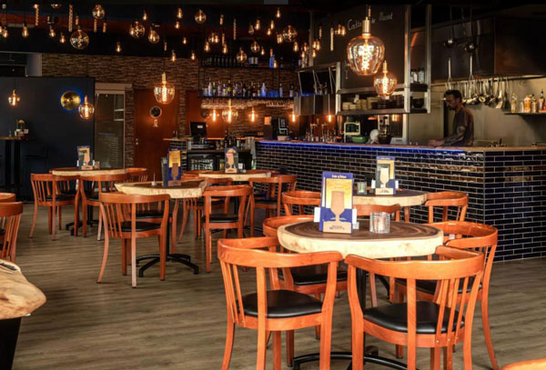 Overzicht van restaurant met houten tafels en stoelen in Utrecht
